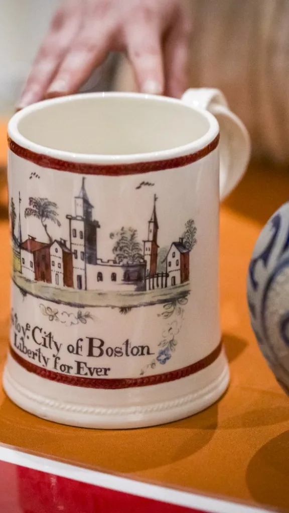 18th century style mugs sit on wooden table 