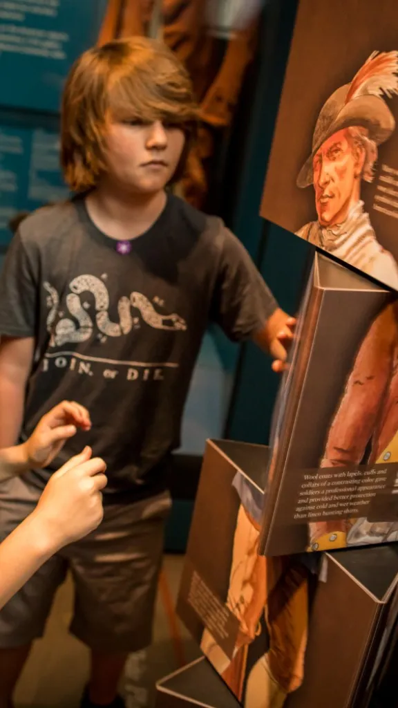 Two kids interact with an interactive photo twister