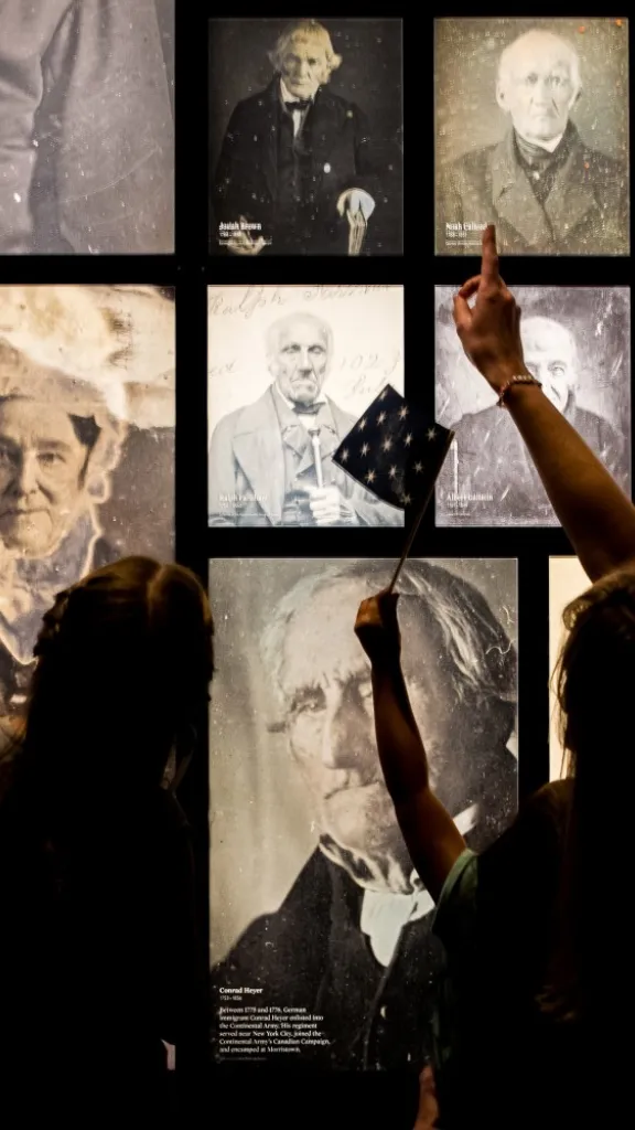 A mother and daughter view photo gallery wall of 19th century people