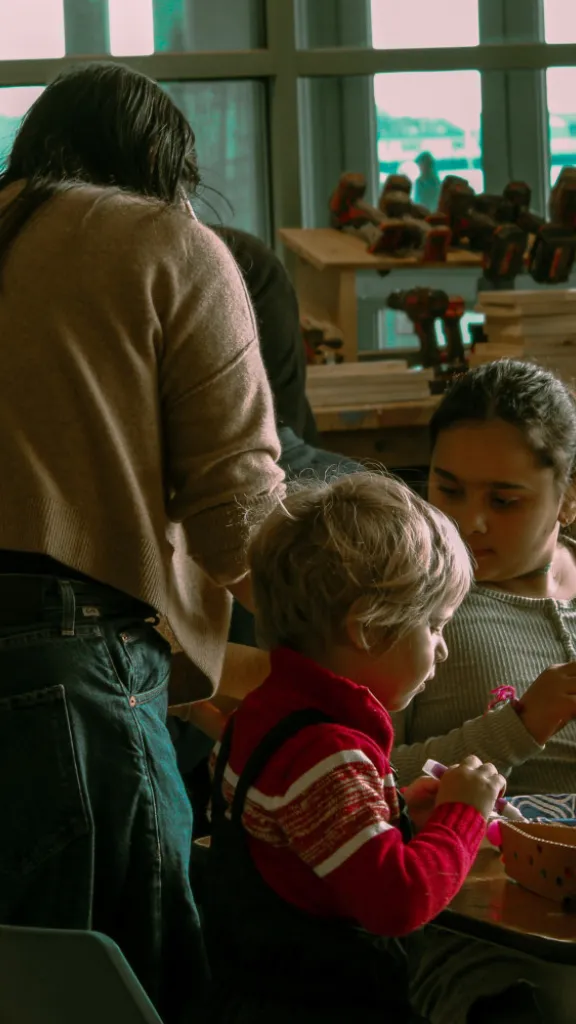 Children and Parents Building Gingerbread Boats During Winter on the Waterfront.