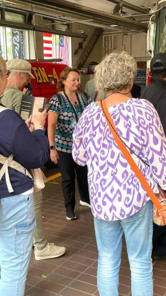 people gathered for a tour in a fire station