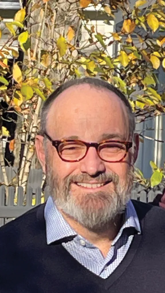 Two men with grey hair and a grey beard and mustache