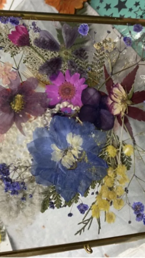 Brass and glass framed pressed flowers by workshop participant