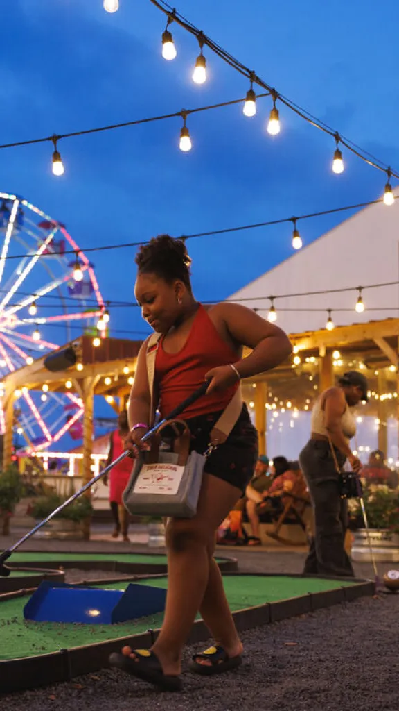 A person mini-golfing