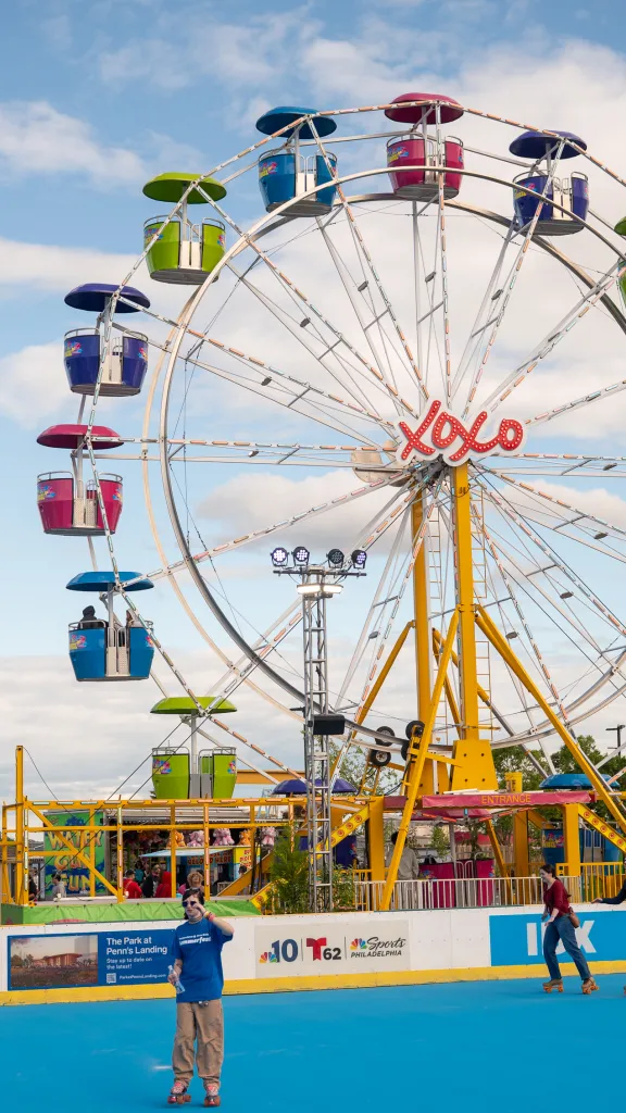 An image of a ferris wheel and roller skaters