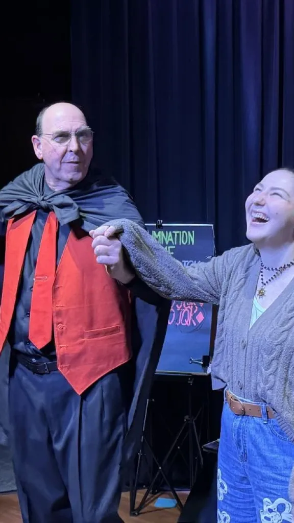Woman smiling reacting to a magic trick