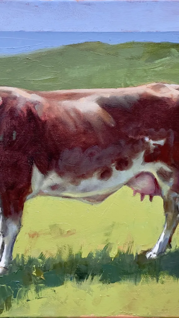 A red and white cow stands demurely in a vivid green field, a glimpse of the Irish Sea beyond. “Irish Cow” oil on canvas 16 x 20 inches 2026