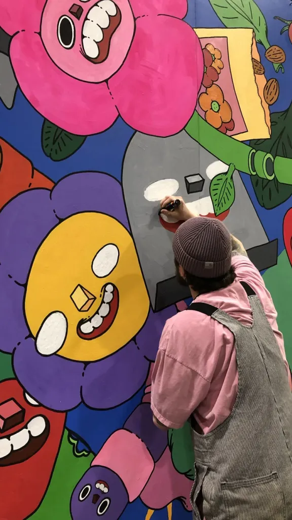 Artist Mr. Scooots painting a mural in Philadelphia
