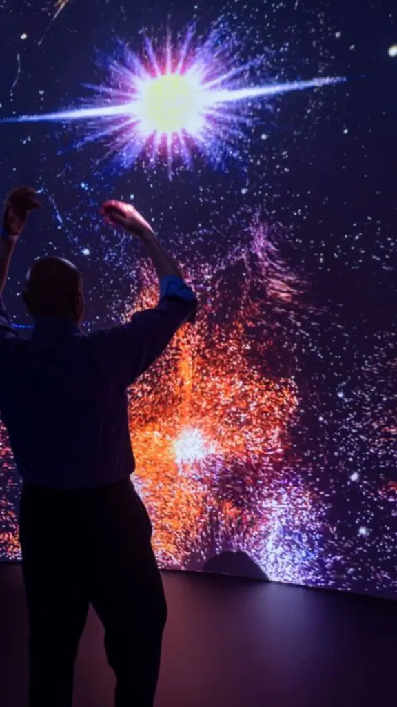 Photo of visitor interacting with immersive Colors fo Creation space.