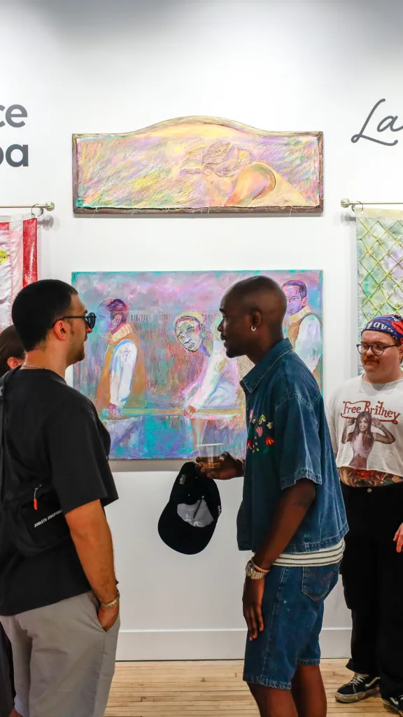 Crowd viewing artwork by Eustace Mamba