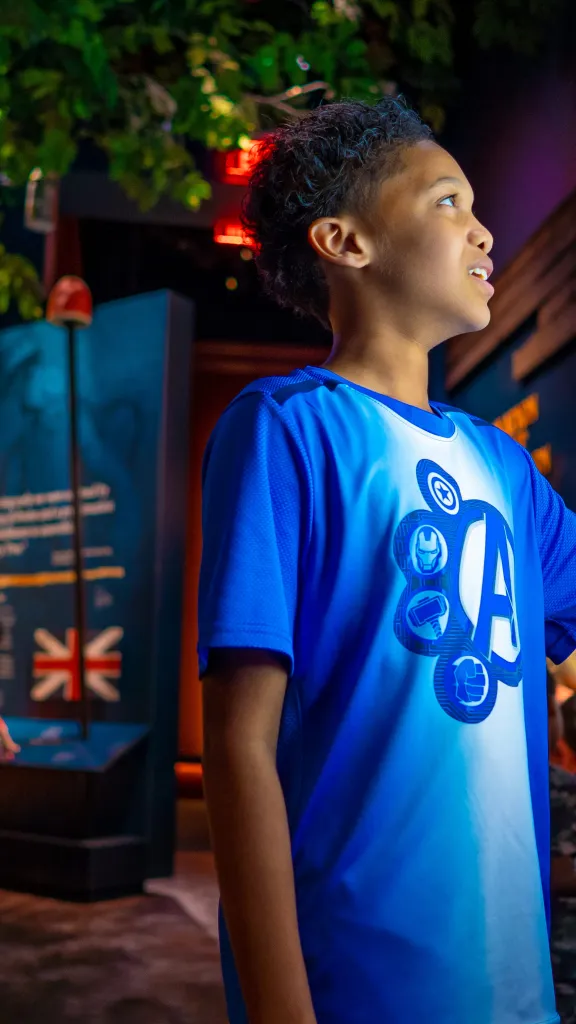 kid in blue shirt uses digital touch screen