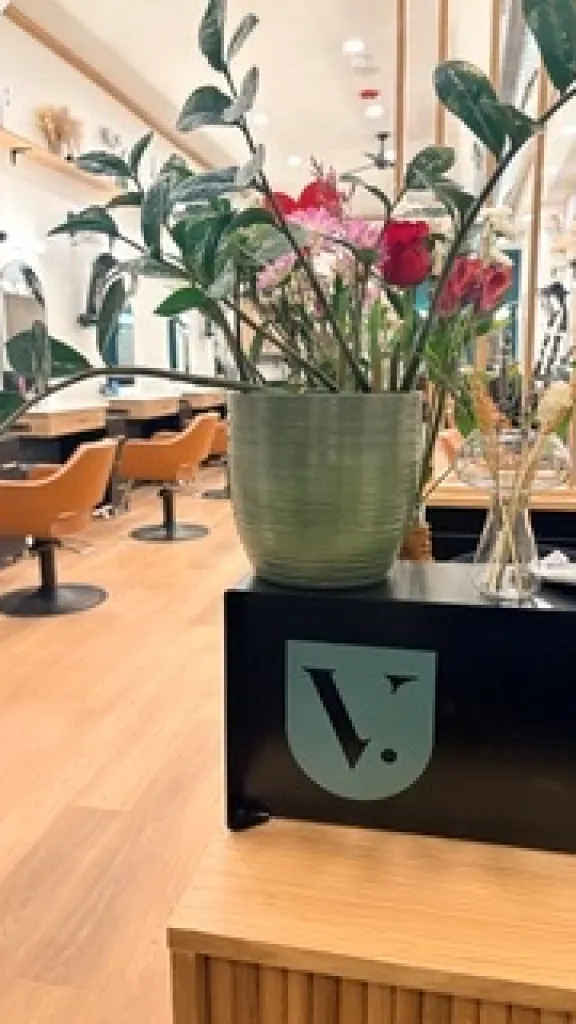 Salon tables with a house plant sitting on top 