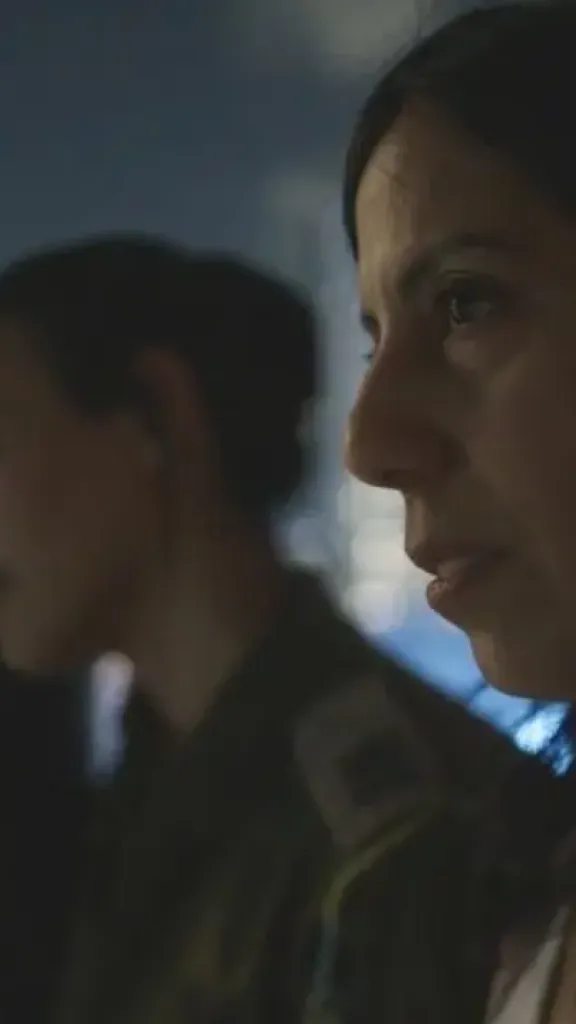 Still from the movie of 4 people looking over a city