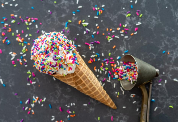 Vanilla ice cream cone with rainbow sprinkles