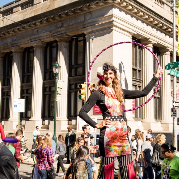 Circus performer standing in crowd at Old City Fest
