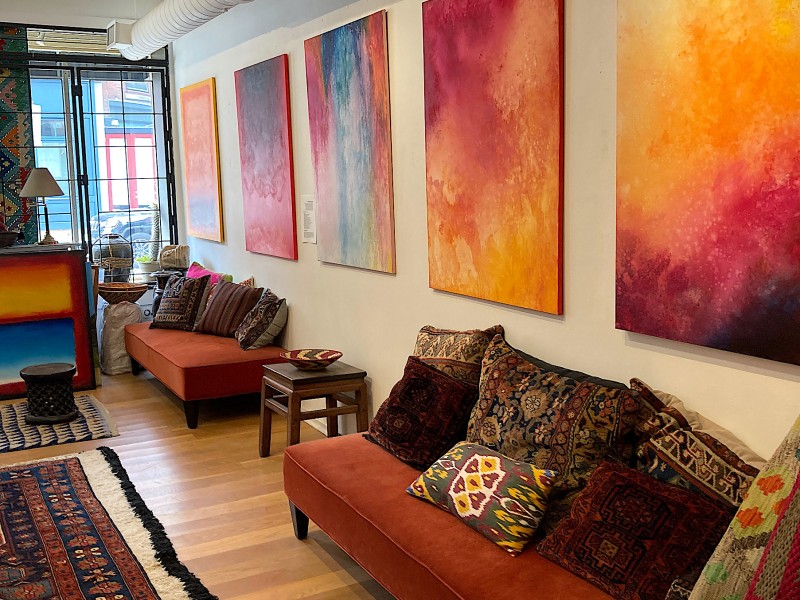Interior of Gallery51 with artwork on walls and furniture and furnishings on display