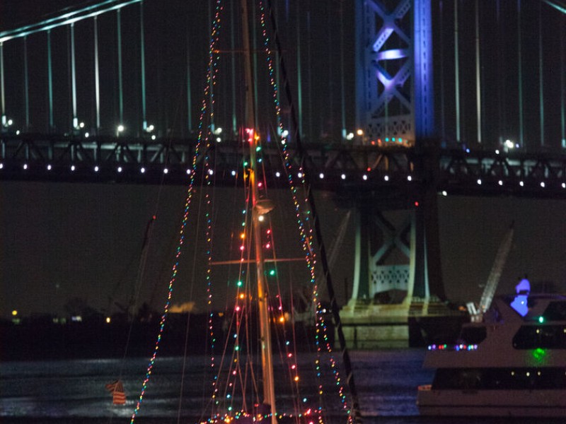 Boat with holiday lights sailing on the Delaware River as part of the Parade of Lights