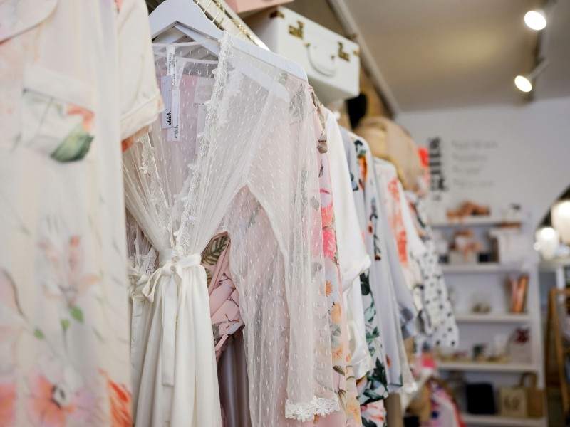Interior of Chick Invitations with rack of clothing on display