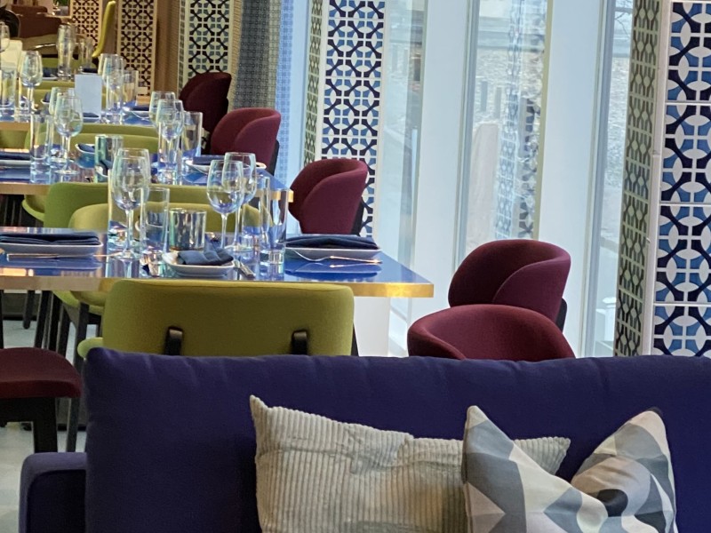 Tables and chairs inside of Positano Coast restaurant