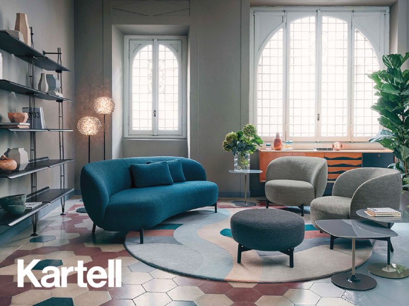 kartell furniture on display in a living room including a blue sofa and two gray chairs