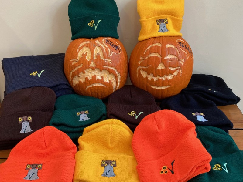 Two pumpkins with American Vegan Center hats