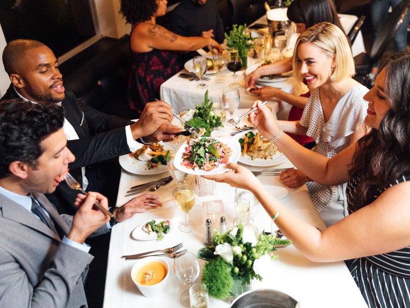 Group of people eating at table.