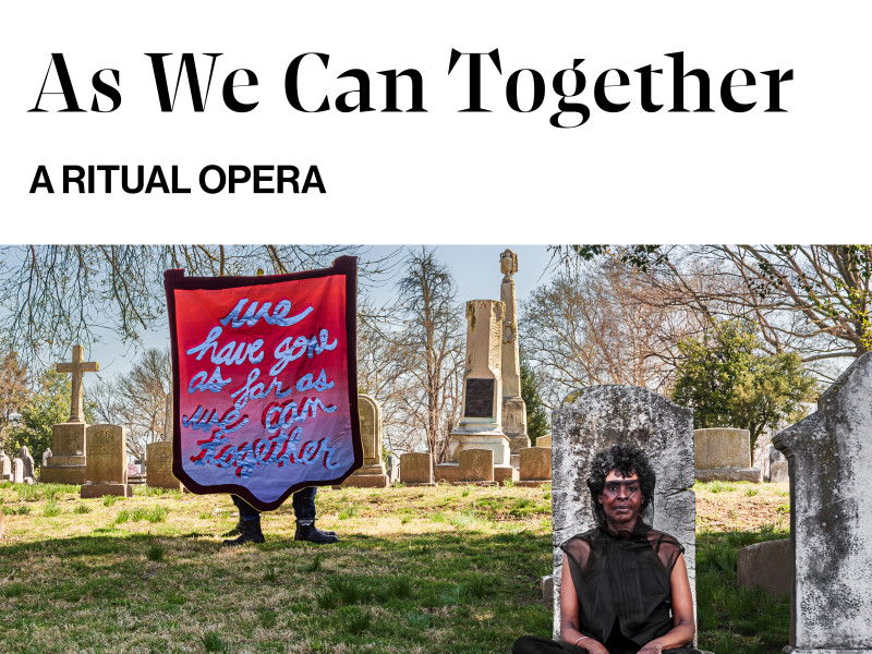 In the midst of a cemetery, one performer sits to the right of a banner that reads: We Have Gone As Far As We Can Together.