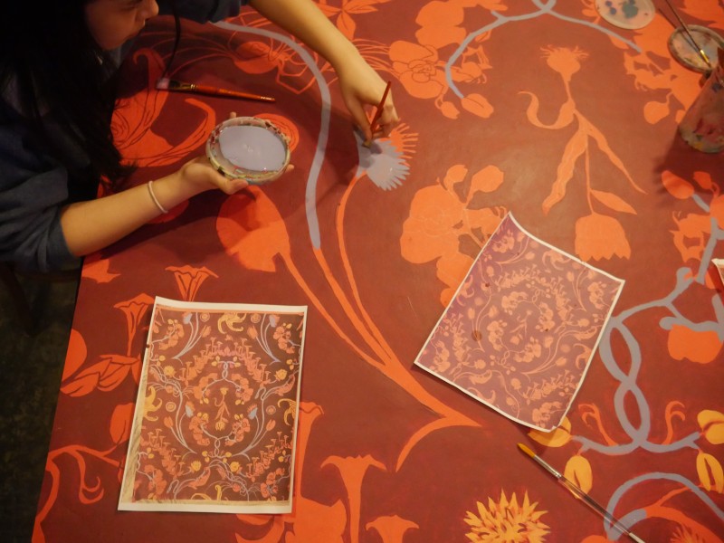 Ministry of Awe First Friday participant painting damask wallpaper.