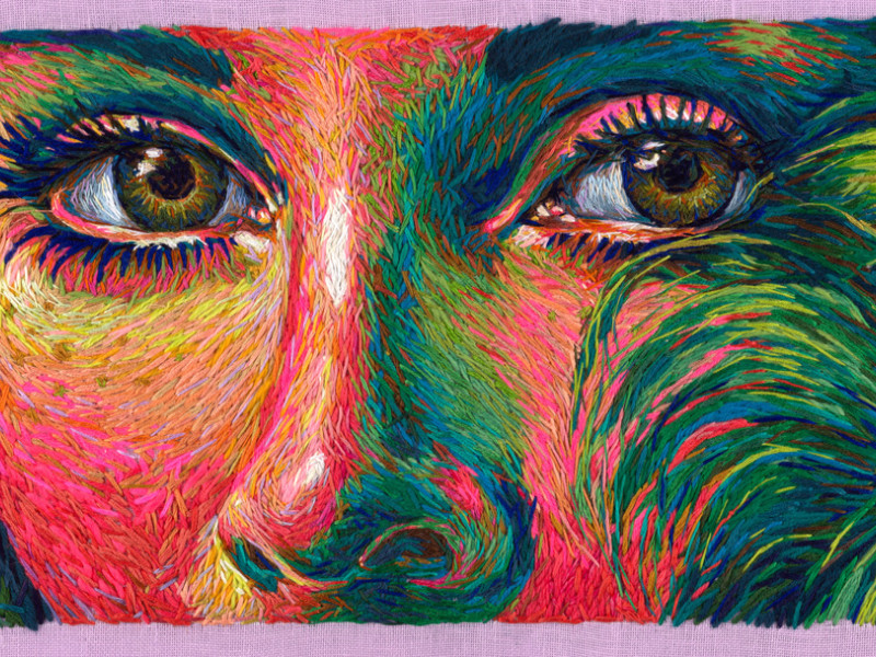 Close-up of embroidered portrait in saturated tones