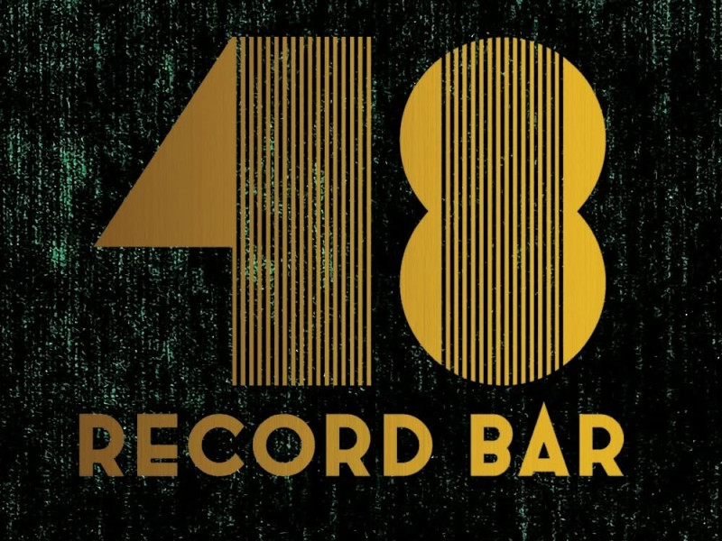 A logo for 48 Record Bar featuring gold letters on a black background