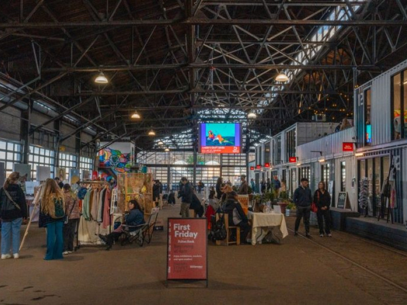 This photo depicts the interior of Cherry Street Pier in Philadelphia during a "First Friday" event.The pier is a repurposed municipal shipping pier featuring converted shipping container artist studios and public market spaces.