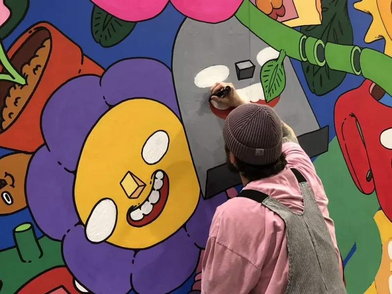 Artist Mr. Scooots painting a mural in Philadelphia