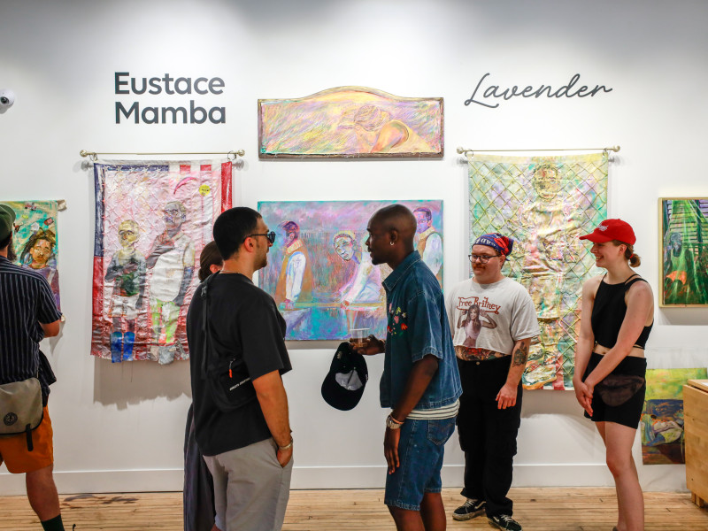 Crowd viewing artwork by Eustace Mamba