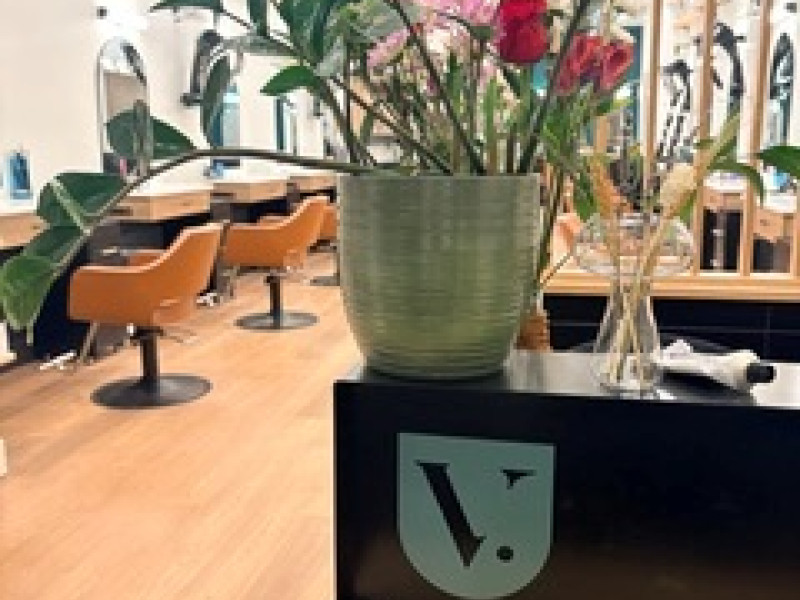 Salon tables with a house plant sitting on top 