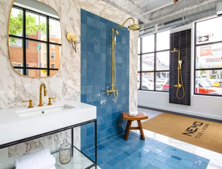 Interior of Nemo Tile + Stone with blue tile and marble sink on display