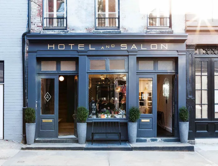 Exterior of Lokal Hotel with "Hotel and Salon" signage above and front door to hotel