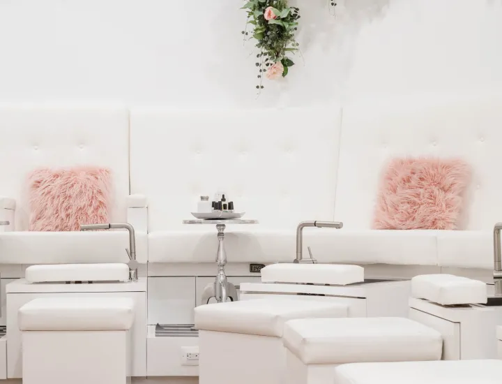 Interior of Lacquer Lounge with white stations and pink fluffy pillows