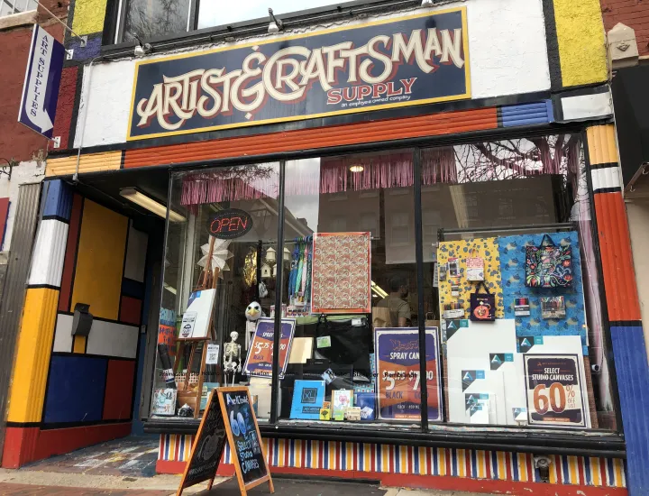 Exterior of Artist & Craftsman Supply, with front entrance and large window display
