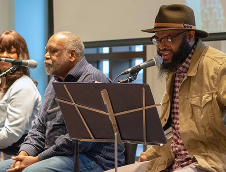 Three people seated speaking through microphones at the Museum of the American Revolution