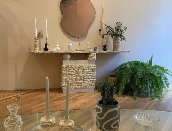 Interior of Casa Vida shop with mirror on wall and items on display as well as table with items on display and a plant