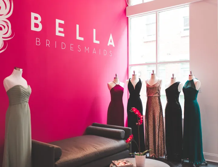 Six bridesmaids dresses on display on mannequins inside Bella Bridesmaids shop