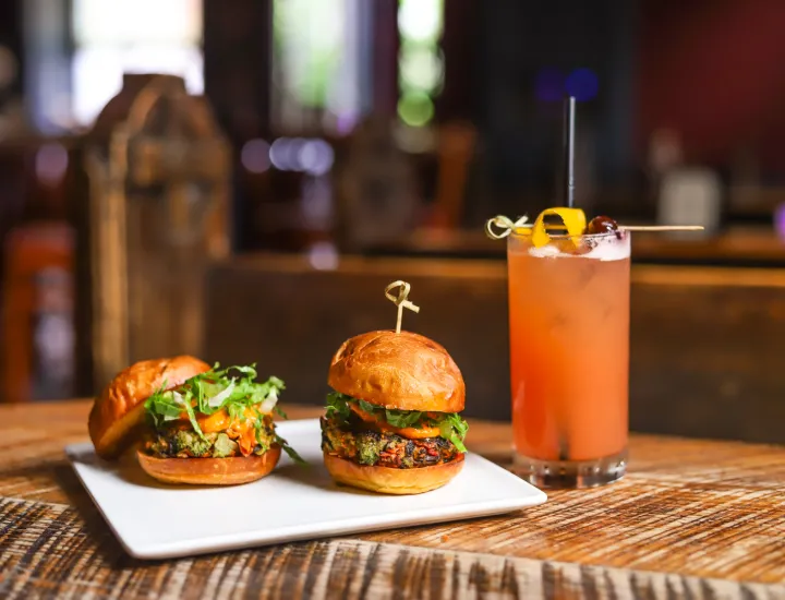 Two sliders and a drink on display at National Mechanics