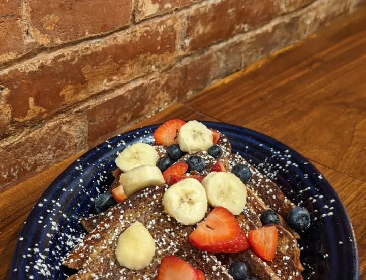 French toast with fruit on a plate at the cafe