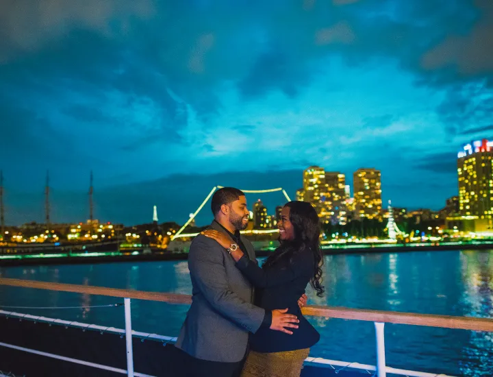 Couple on outer deck of vessel.