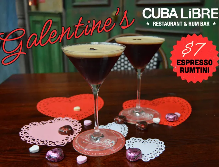 Two espresso martinis on a table decorated with heart coasters and chocolates; Galentine's and $7 espresso martini text