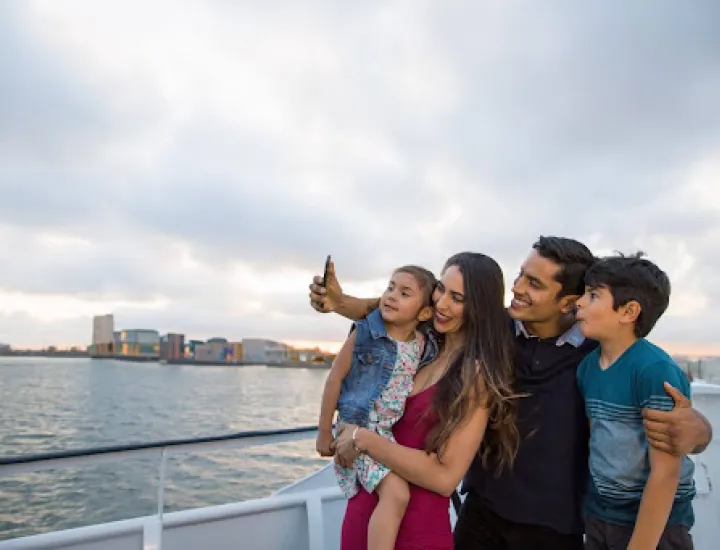 Family posing for a photo while aboard City Cruises 