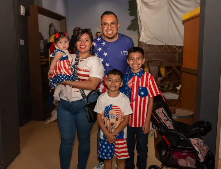 Family of five  dressed up in red, white, and blue celebrating the 4th of July at The Weitzman