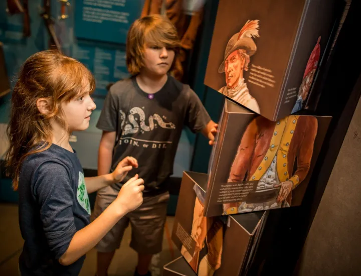 Two kids interact with an interactive photo twister