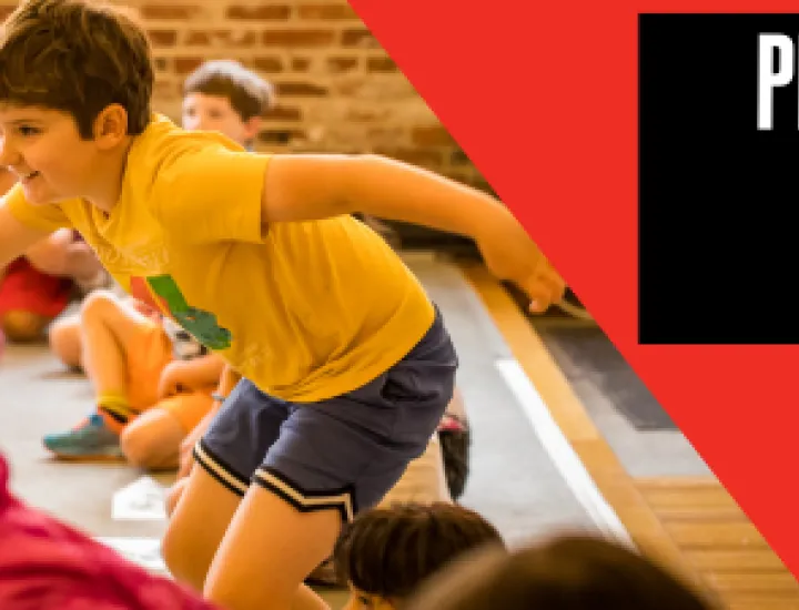 A child getting up to run to the middle of a circle of children. Text that reads "Play-in-a-Day. Grades K-5."