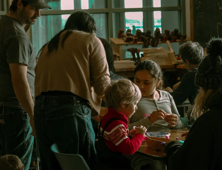 Children and Parents Building Gingerbread Boats During Winter on the Waterfront.